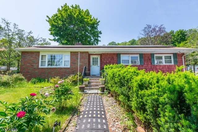 a house with a flower garden in front of it