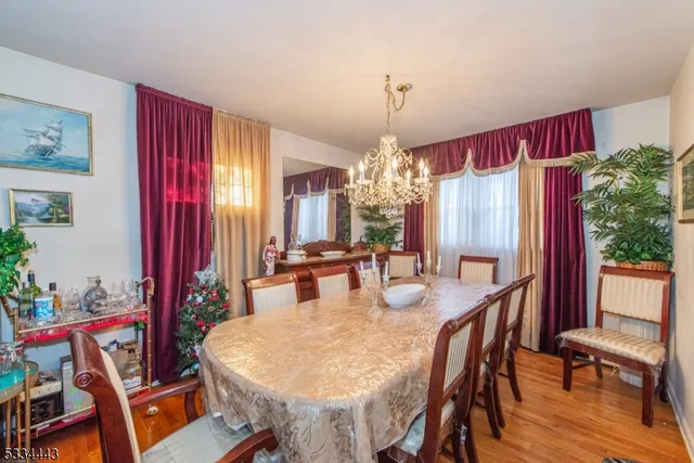 a kitchen with stainless steel appliances granite countertop a stove a sink dishwasher and cabinets with wooden floor