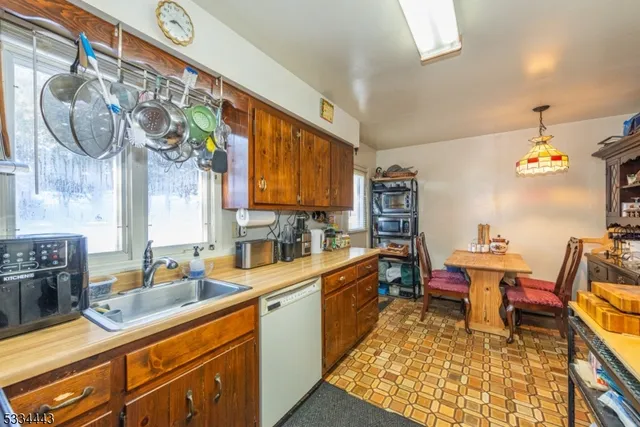 a kitchen with a table chairs sink and cabinets
