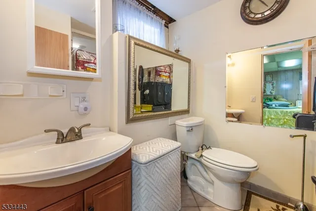 a bed room with a bed mirror and a window