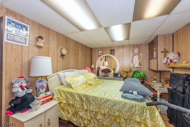 a living room with furniture a flat screen tv and a floor to ceiling window