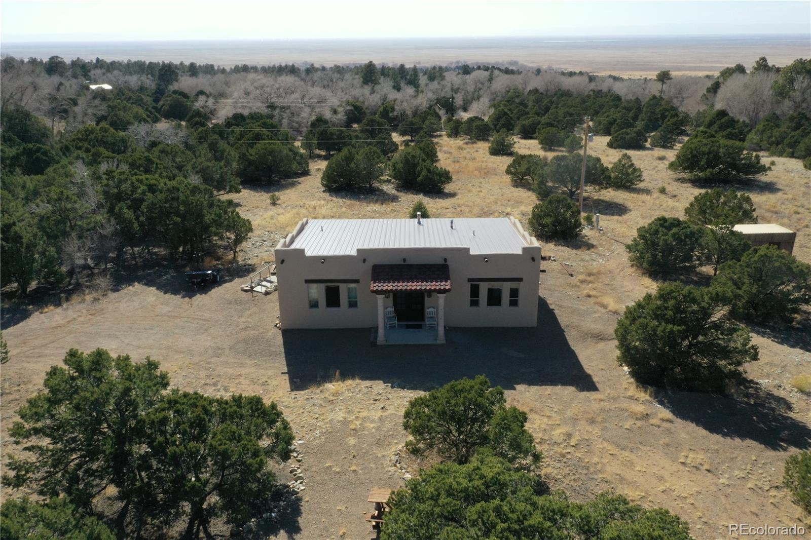 an aerial view of a house with a yard