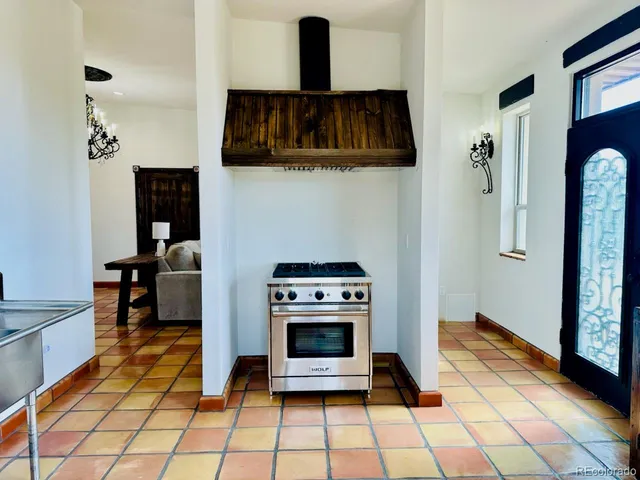 a kitchen with stainless steel appliances kitchen island a stove a sink and a refrigerator