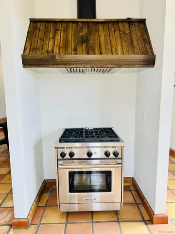 a stove top oven sitting inside of a kitchen