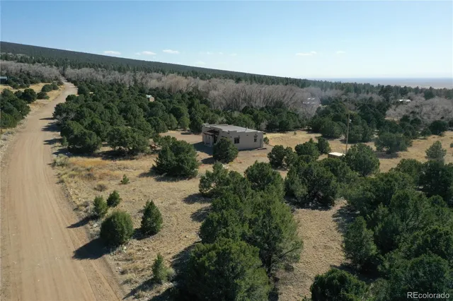 a view of a field with mountains in the background