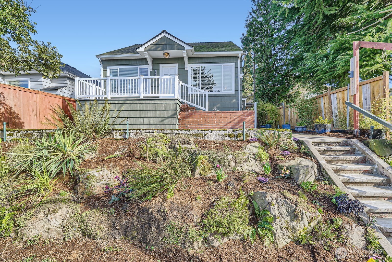 3630 46th Avenue Southwest Seattle, WA 98116 - Photo 1 of 29 a front view of a house with a yard