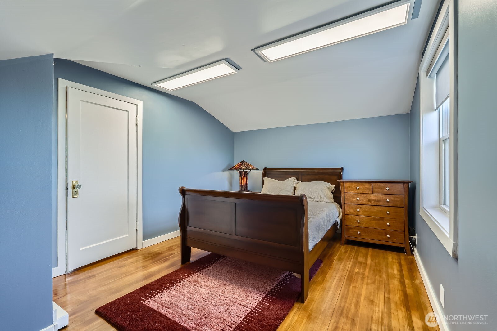 3630 46th Avenue Southwest Seattle, WA 98116 - Photo 15 of 29 a bed room with a bed and a window