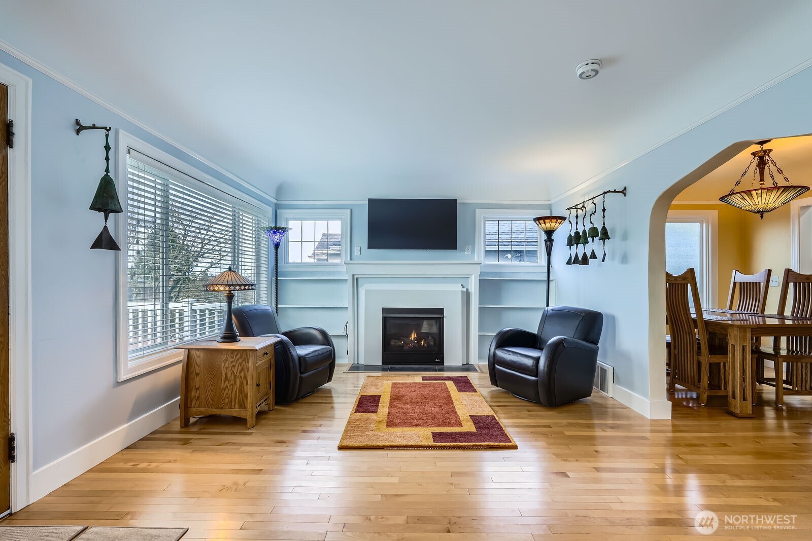 3630 46th Avenue Southwest Seattle, WA 98116 - Photo 5 of 29 a living room with furniture flat screen tv and a fireplace