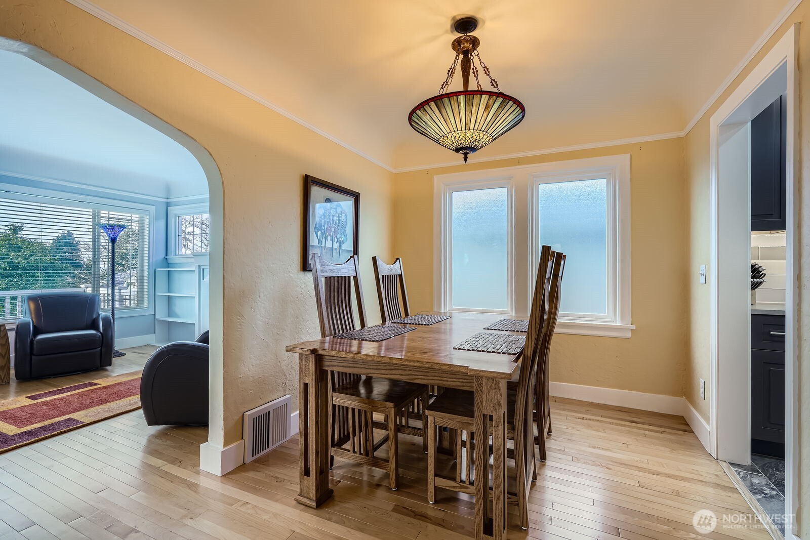 3630 46th Avenue Southwest Seattle, WA 98116 - Photo 6 of 29 a view of a dining room with furniture window and wooden floor