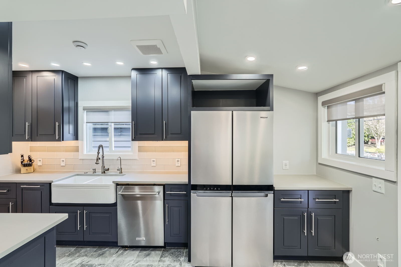 3630 46th Avenue Southwest Seattle, WA 98116 - Photo 9 of 29 a kitchen with stainless steel appliances a refrigerator and a sink