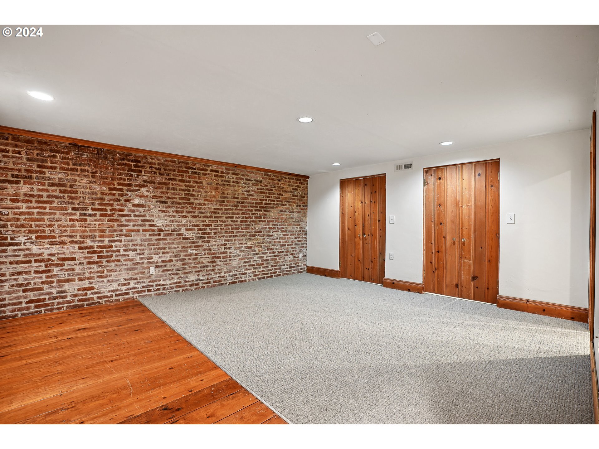 3903 North Michigan Avenue Portland, OR 97227 - Photo 12 of 47 a view of an empty room with wooden floor