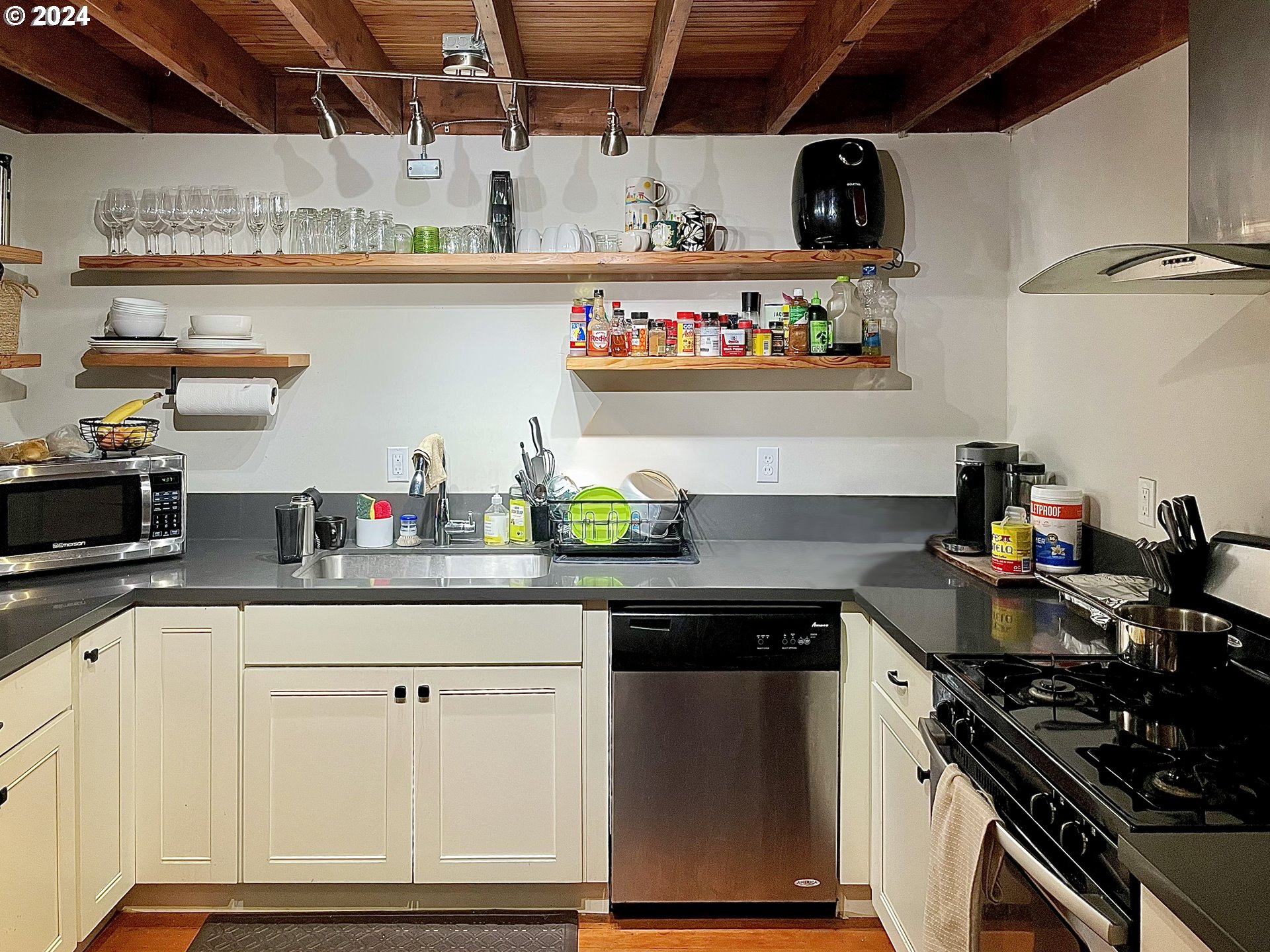 3903 North Michigan Avenue Portland, OR 97227 - Photo 42 of 47 a kitchen with stainless steel appliances granite countertop a lot of white cabinets