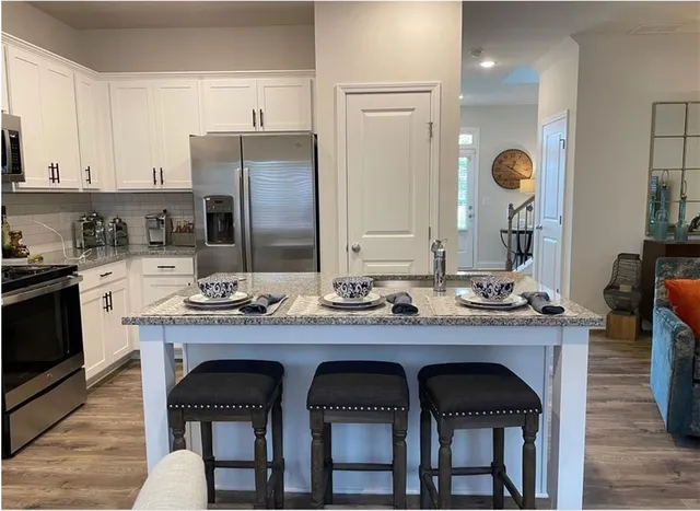 a kitchen with a table and chairs in it