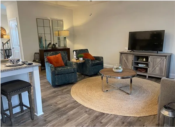a living room with furniture and a flat screen tv