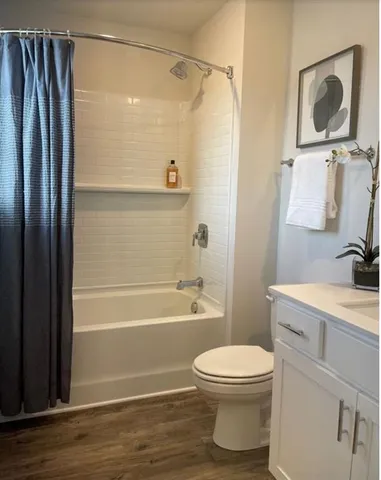 a bathroom with a toilet a sink and bathtub