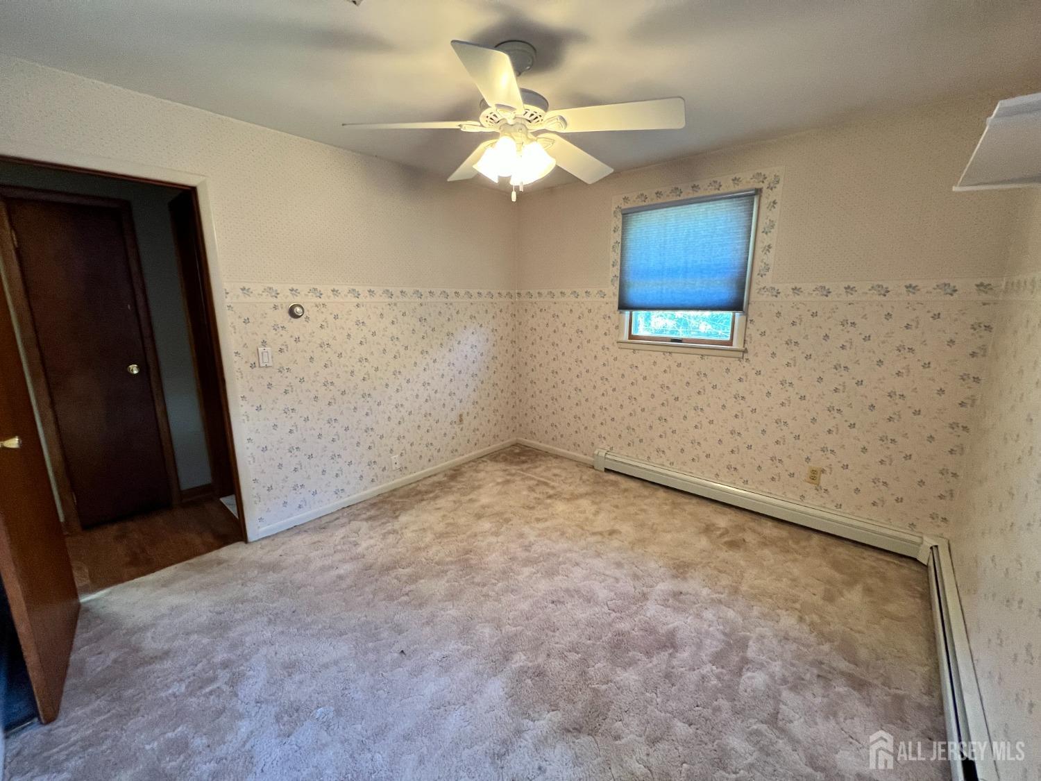 283 Rudetown Road Hamburg, NJ 07419 - Photo 11 of 38 en empty room with windows and fan