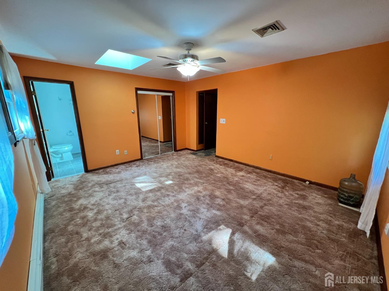 283 Rudetown Road Hamburg, NJ 07419 - Photo 16 of 38 an empty room with a ceiling fan and window