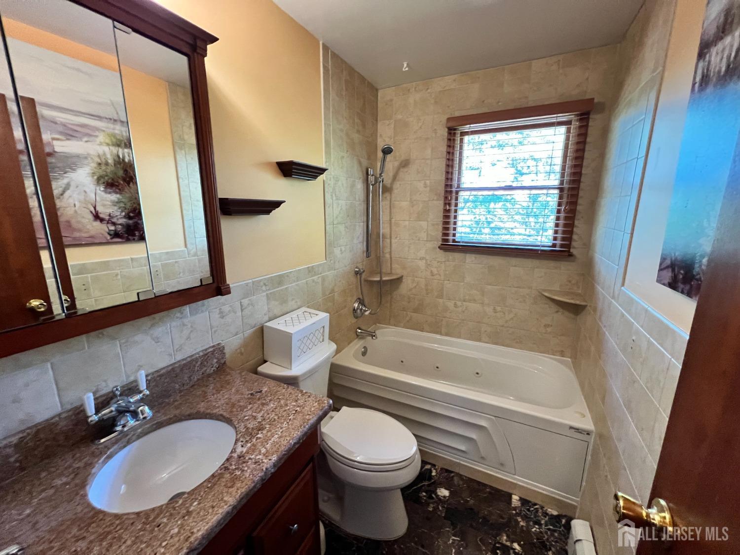 283 Rudetown Road Hamburg, NJ 07419 - Photo 24 of 38 a bathroom with a granite countertop toilet sink and tub