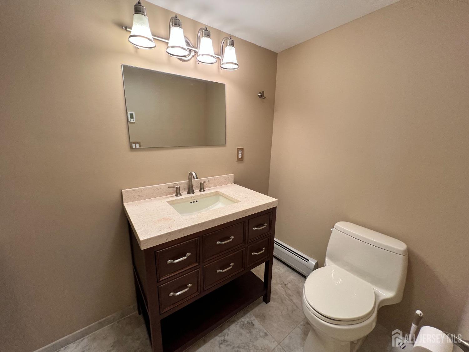 283 Rudetown Road Hamburg, NJ 07419 - Photo 26 of 38 a bathroom with a toilet sink and mirror