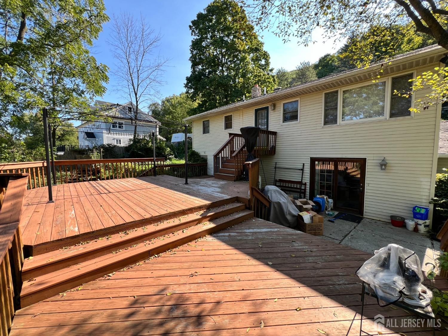 283 Rudetown Road Hamburg, NJ 07419 - Photo 37 of 38 a patio with couches and a dining table and chairs with wooden floor