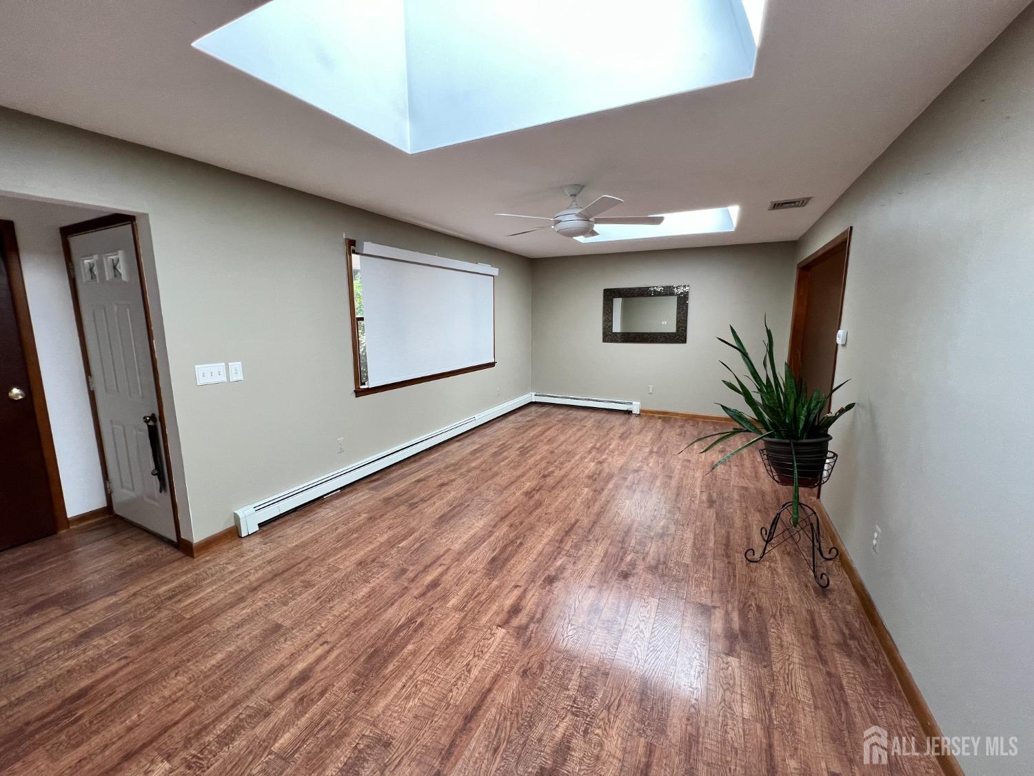 283 Rudetown Road Hamburg, NJ 07419 - Photo 4 of 38 a view of a livingroom with wooden floor and a window