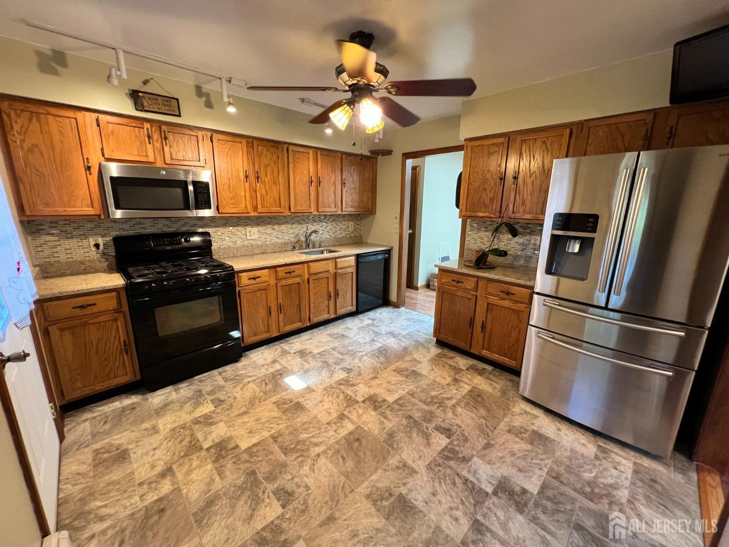 283 Rudetown Road Hamburg, NJ 07419 - Photo 7 of 38 a kitchen with granite countertop a refrigerator a stove top oven a sink and dishwasher