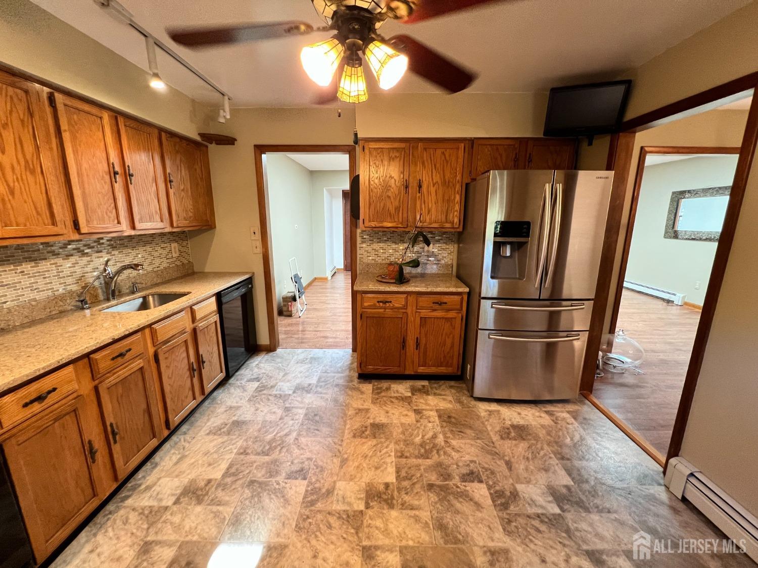 283 Rudetown Road Hamburg, NJ 07419 - Photo 8 of 38 a kitchen with granite countertop a refrigerator a sink a stove a washer dryer and a dining table