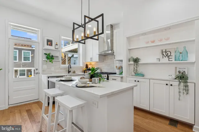 a view of a kitchen with appliances and wooden floor