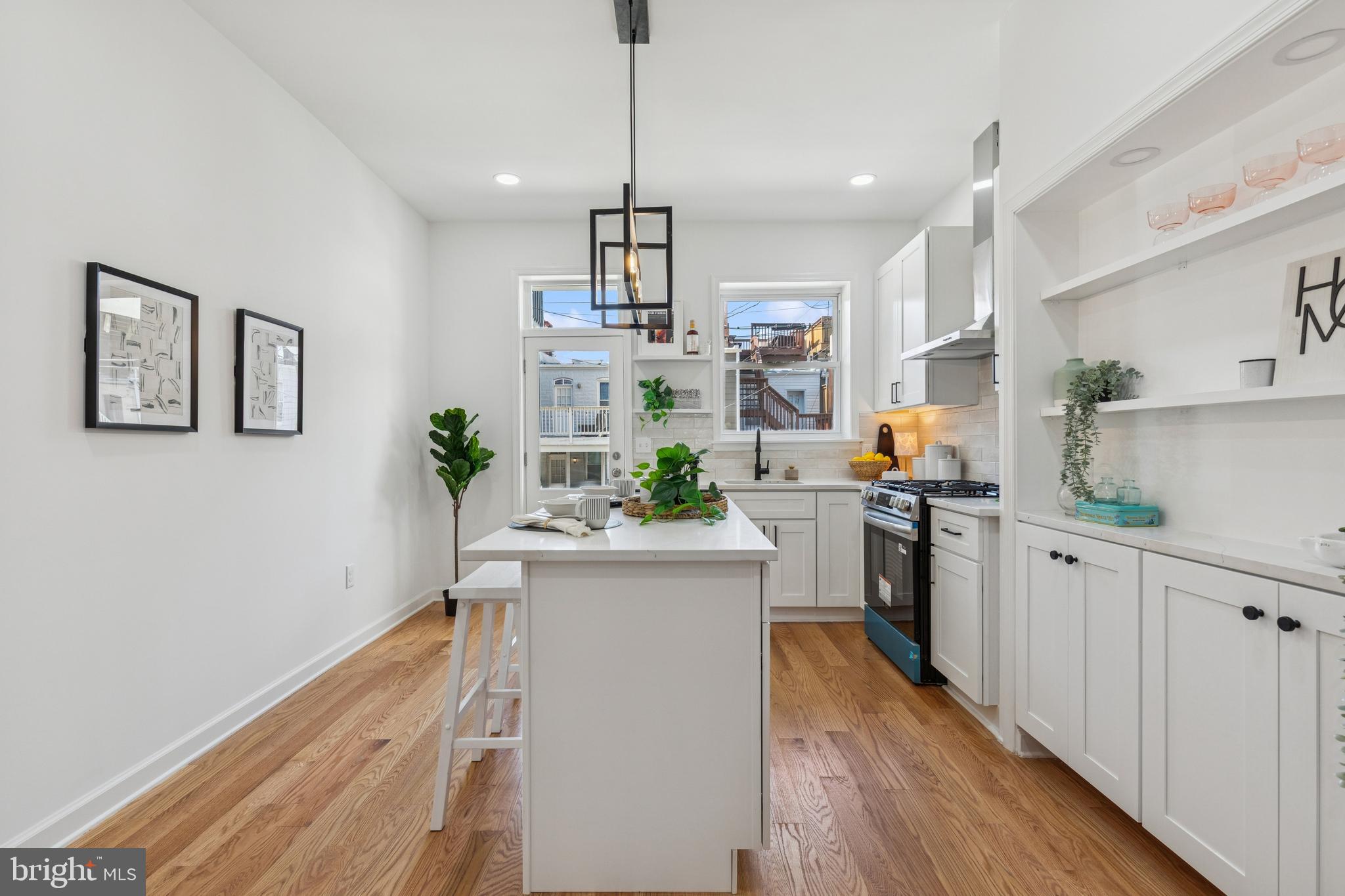 630 South Potomac Street Baltimore, MD 21224 - Photo 20 of 52 a kitchen with white cabinets and stainless steel appliances