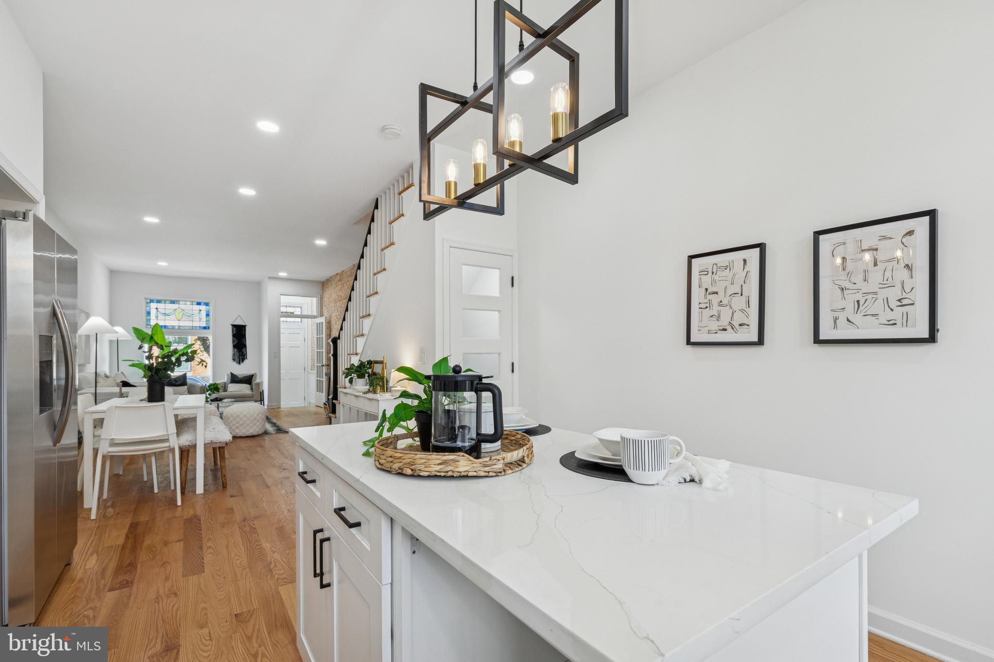630 South Potomac Street Baltimore, MD 21224 - Photo 22 of 52 a view of dining room and kitchen with a table chairs and wooden floor