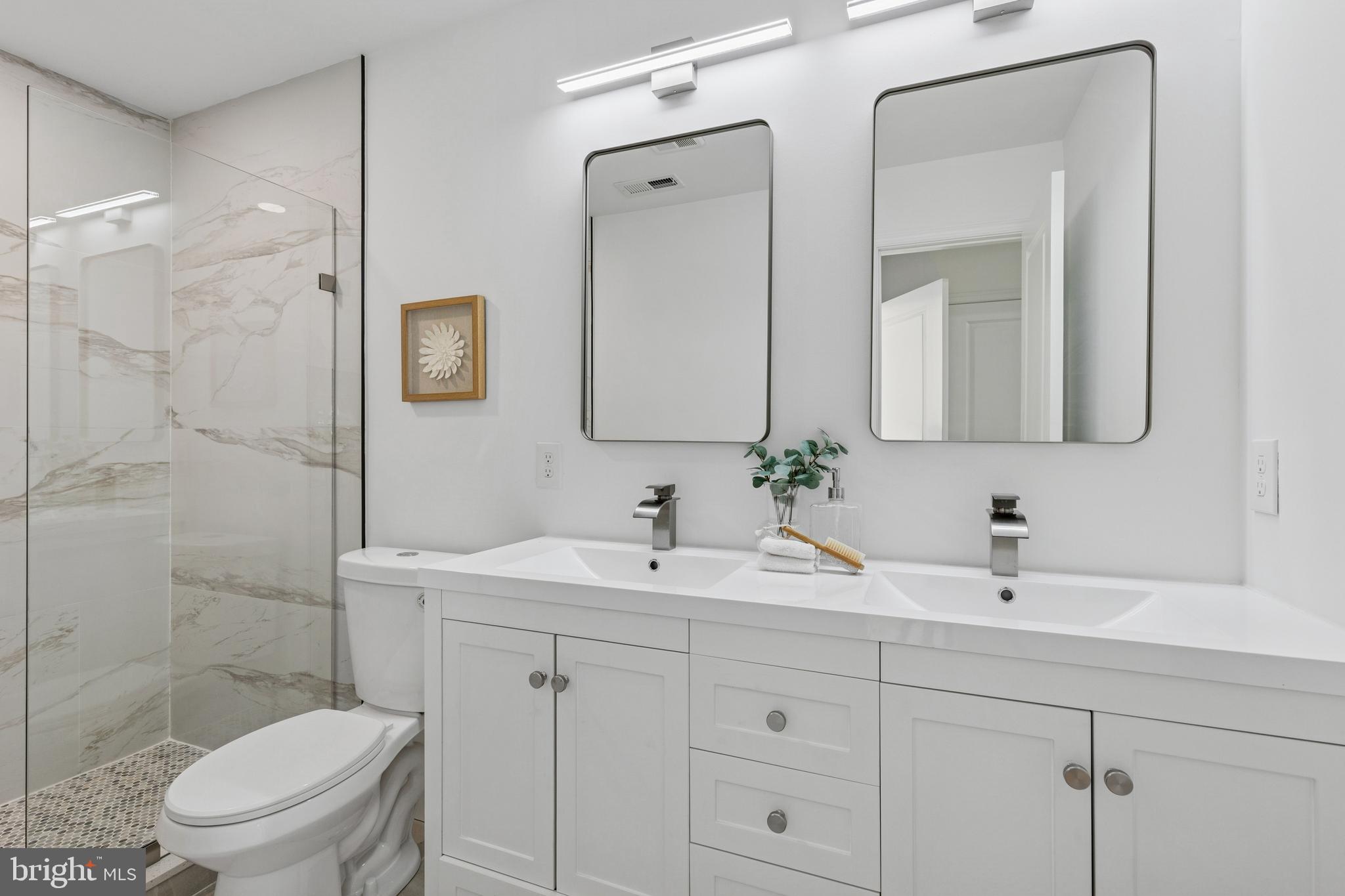 630 South Potomac Street Baltimore, MD 21224 - Photo 25 of 52 a bathroom with a toilet a sink a mirror and shower