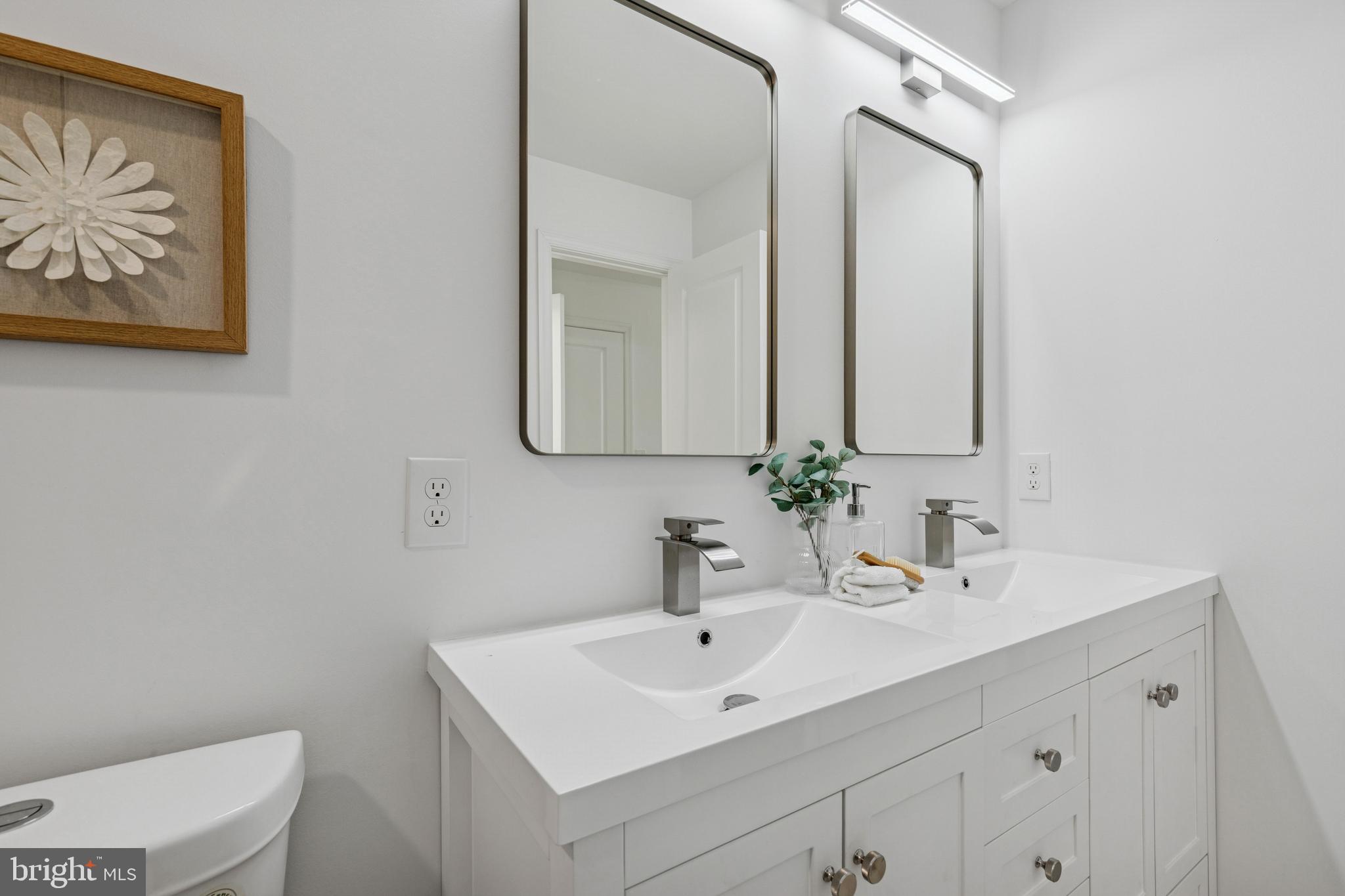 630 South Potomac Street Baltimore, MD 21224 - Photo 26 of 52 a bathroom with a toilet a sink and mirror