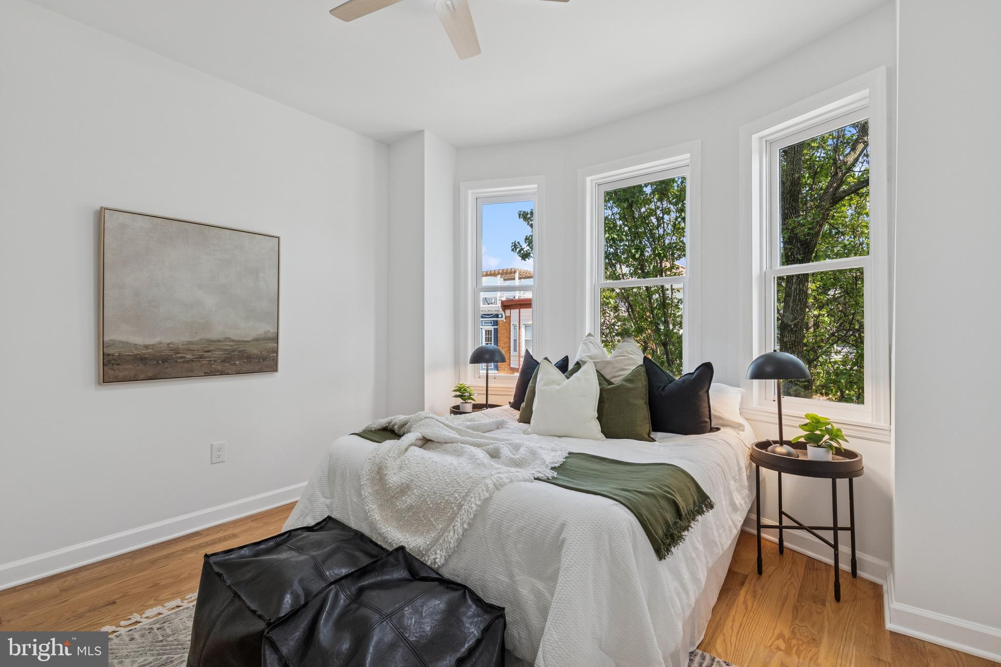 630 South Potomac Street Baltimore, MD 21224 - Photo 28 of 52 a bedroom with a bed and wooden floor