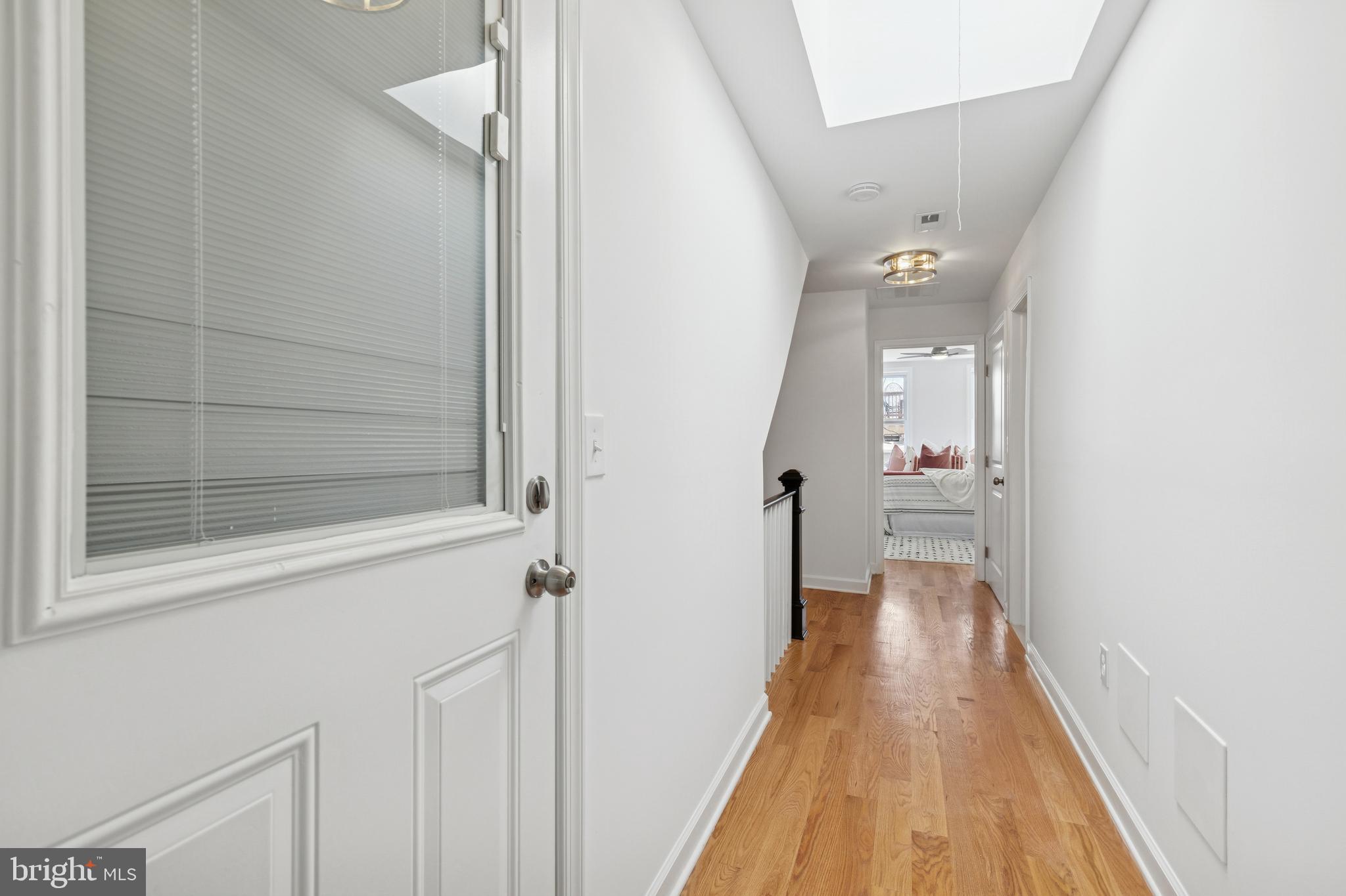 630 South Potomac Street Baltimore, MD 21224 - Photo 32 of 52 a view of a hallway with wooden floor and staircase