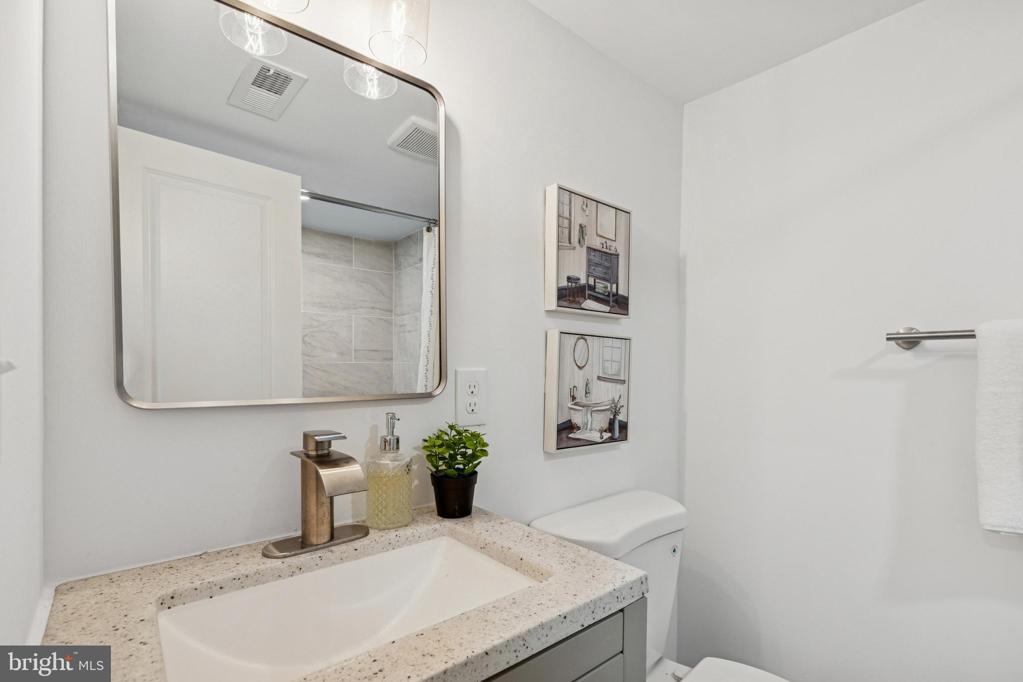630 South Potomac Street Baltimore, MD 21224 - Photo 38 of 52 a bathroom with a granite countertop sink and a mirror