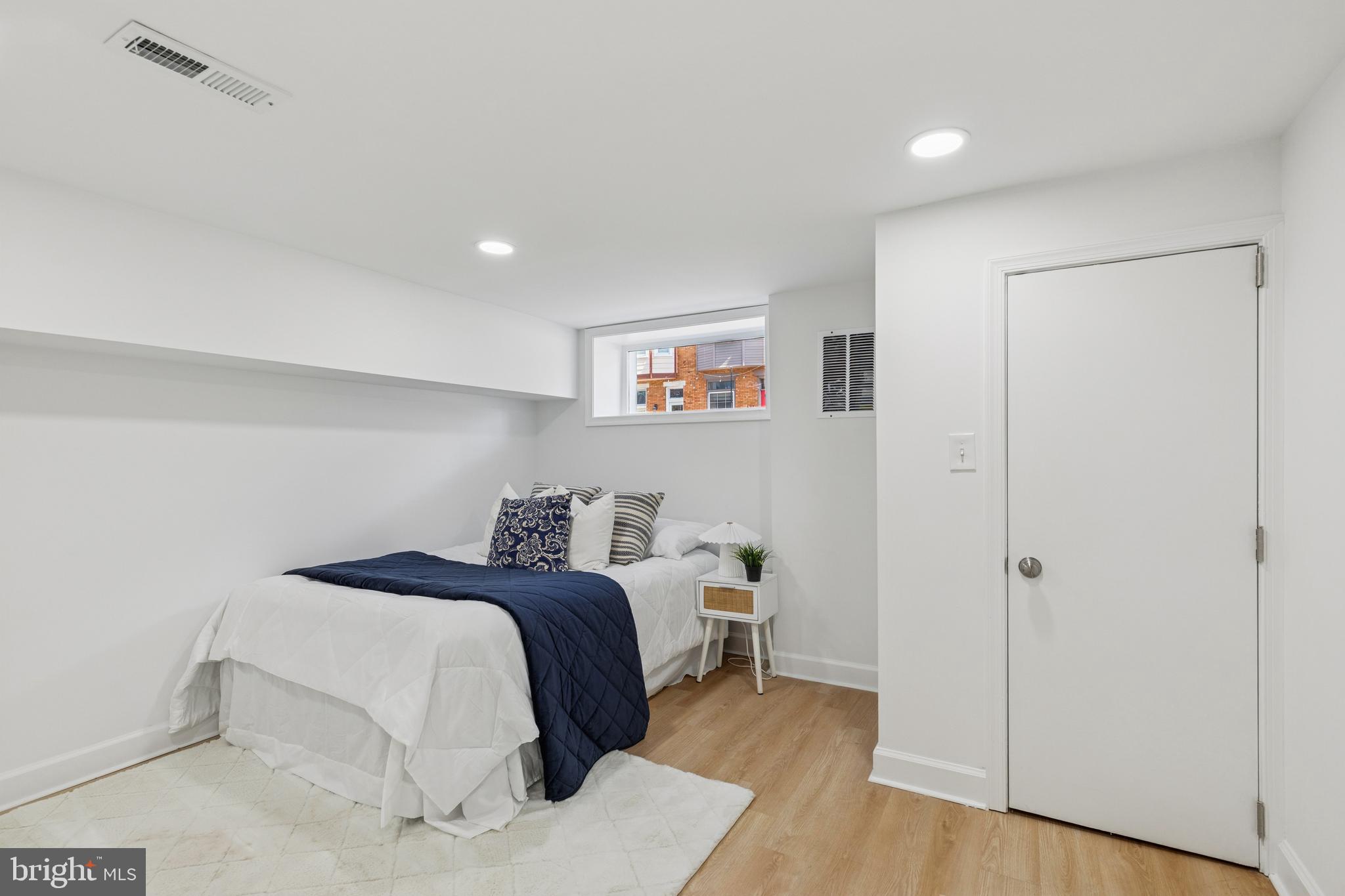 630 South Potomac Street Baltimore, MD 21224 - Photo 40 of 52 a bedroom with a bed and a painting