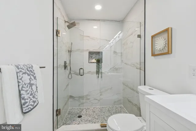 a bathroom with a toilet and a shower