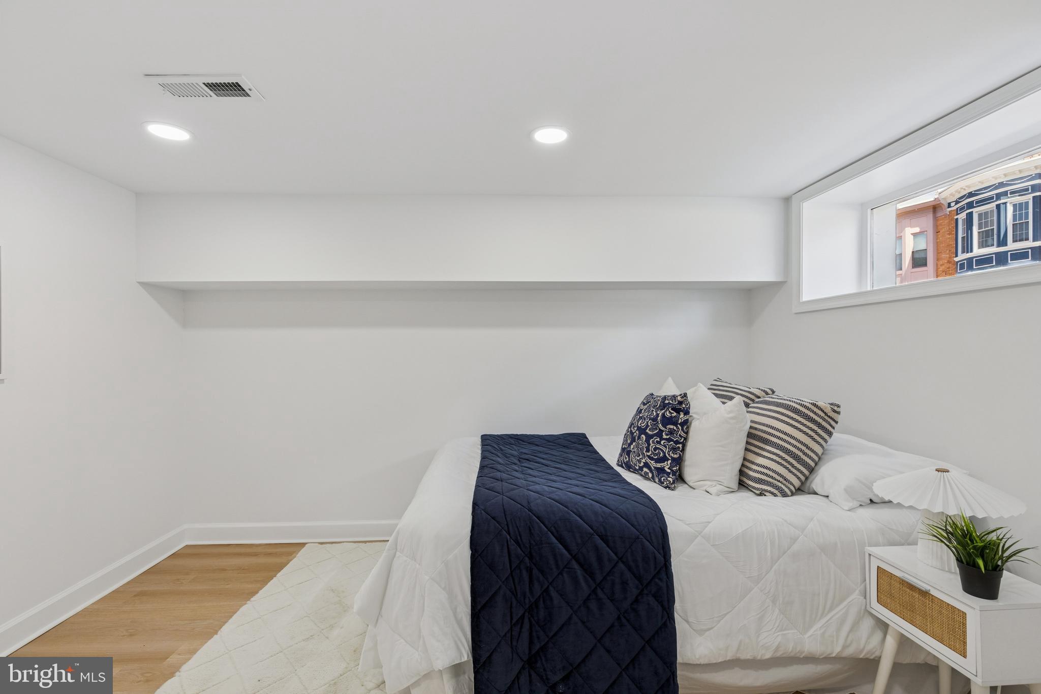 630 South Potomac Street Baltimore, MD 21224 - Photo 42 of 52 a bedroom with a bed and a potted plant