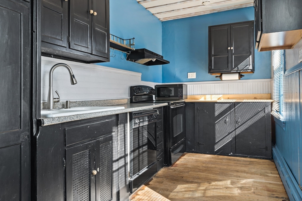 37 Merton Street Somerset, MA 02726 - Photo 14 of 36 a kitchen with stainless steel appliances granite countertop a sink stove and cabinets