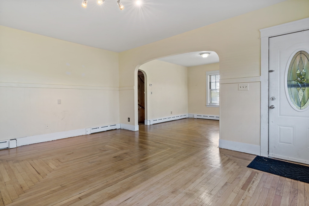 37 Merton Street Somerset, MA 02726 - Photo 5 of 36 an empty room with wooden floor and mirror
