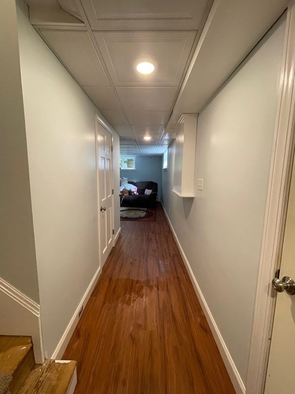 46 Quaker Lane Rochester, MA 02770 - Photo 18 of 25 a view of a hallway with wooden floor and furniture