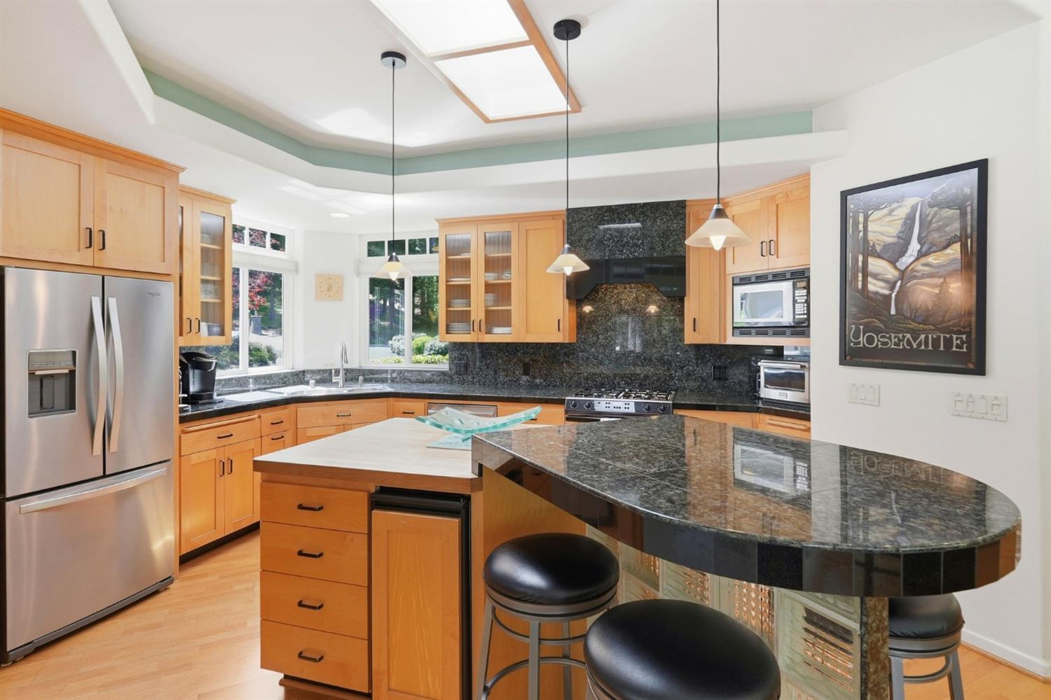 10711 Murchie Mine Road Nevada City, CA 95959 - Photo 16 of 71 a kitchen with stainless steel appliances granite countertop a sink a refrigerator a stove and white cabinets