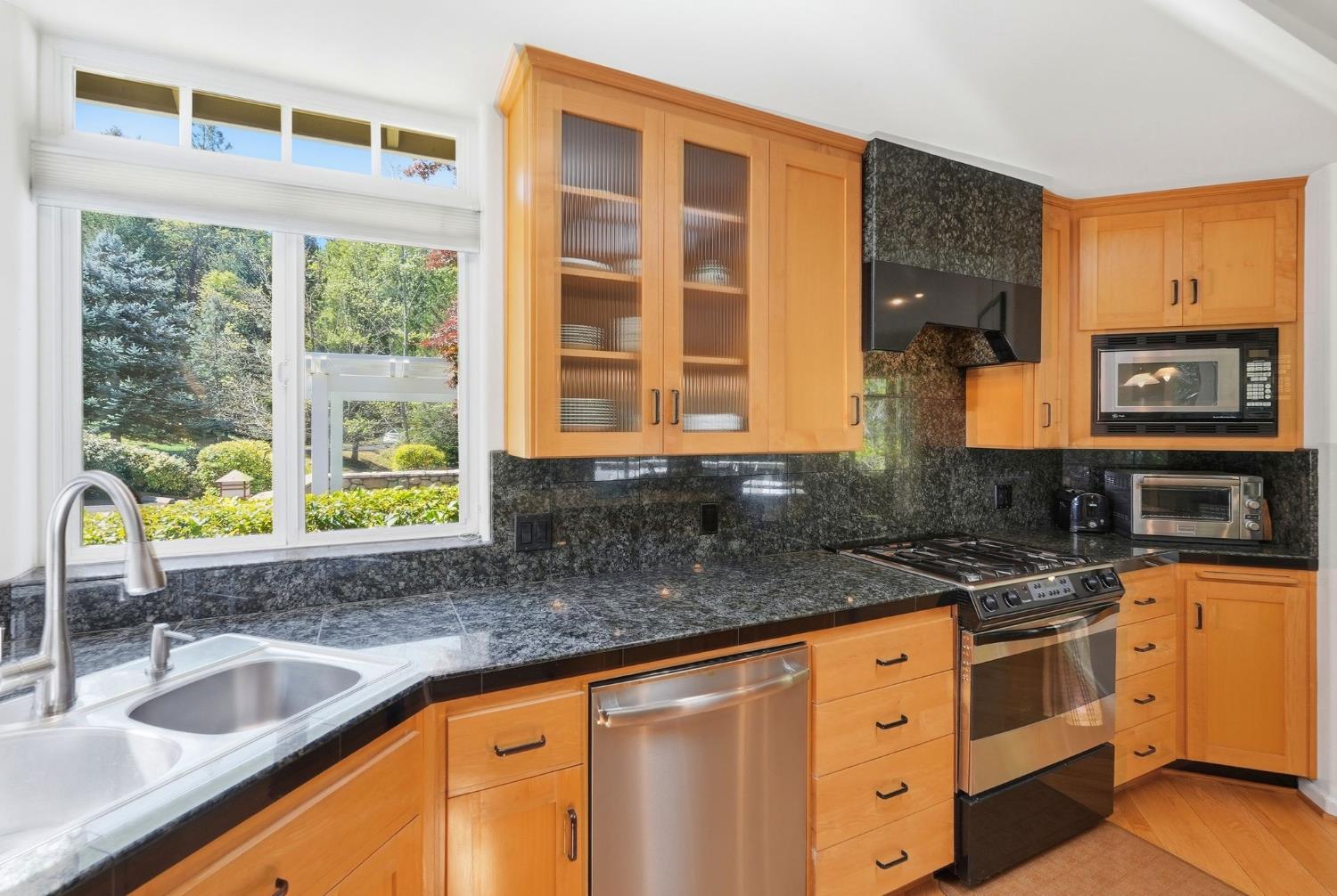 10711 Murchie Mine Road Nevada City, CA 95959 - Photo 18 of 71 a kitchen with granite countertop a sink and a stove