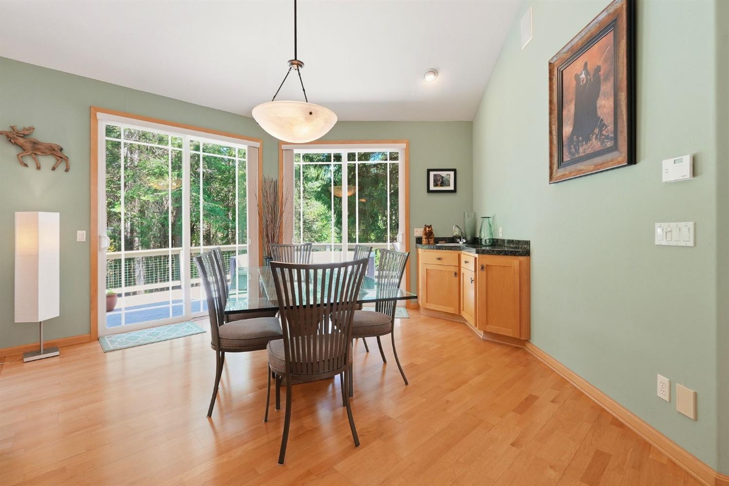 10711 Murchie Mine Road Nevada City, CA 95959 - Photo 21 of 71 a dining room with furniture a chandelier and wooden floor