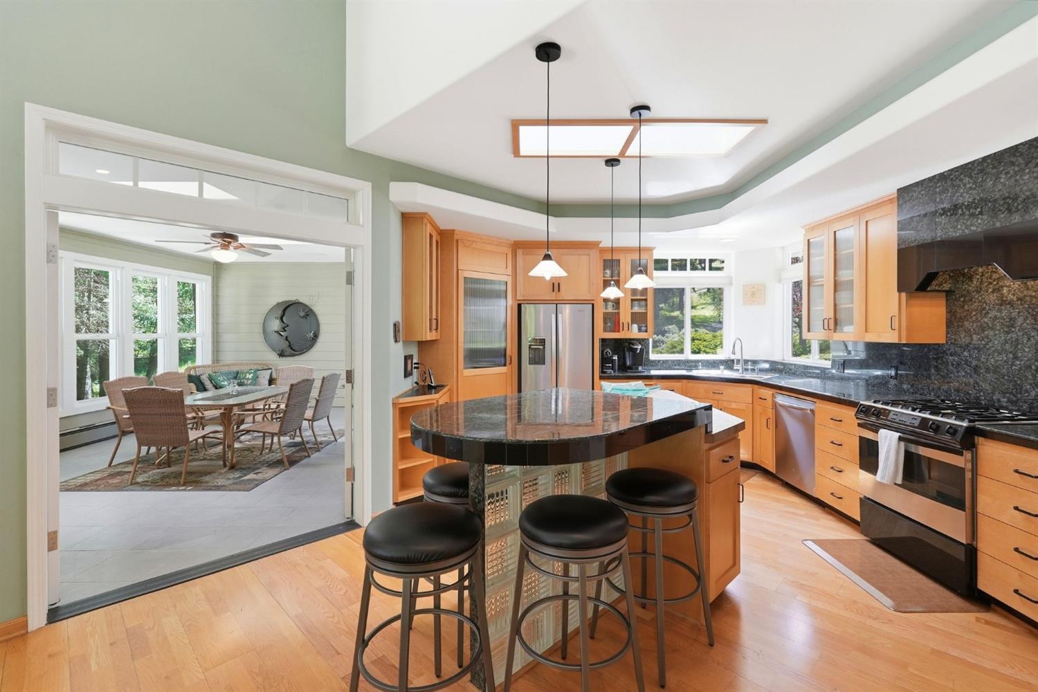 10711 Murchie Mine Road Nevada City, CA 95959 - Photo 24 of 71 a kitchen with stainless steel appliances kitchen island granite countertop a table chairs and a chandelier