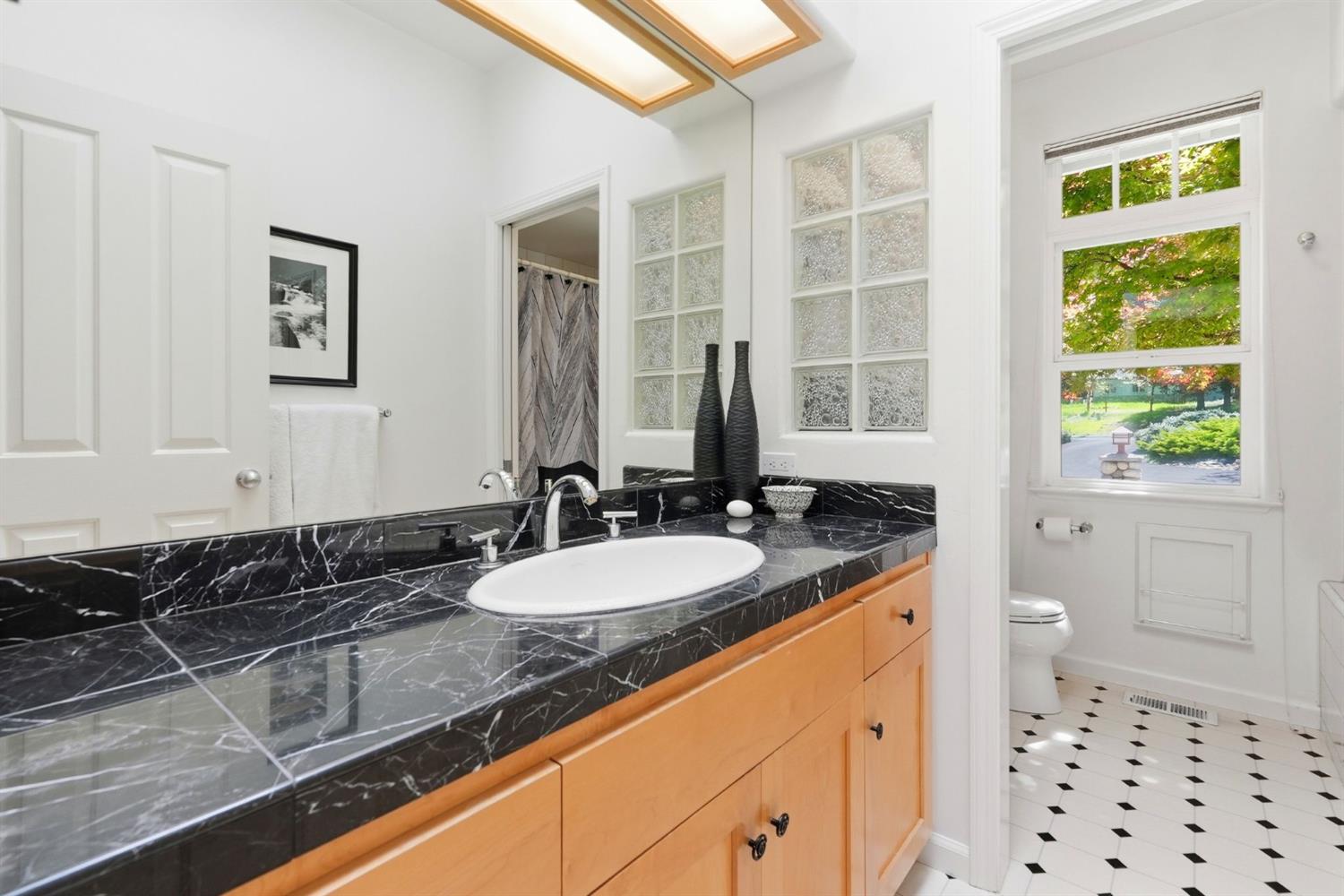 10711 Murchie Mine Road Nevada City, CA 95959 - Photo 45 of 71 a bathroom with a granite countertop sink and a mirror