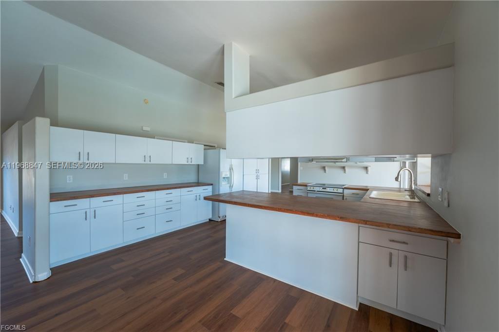 845 Quail Run LaBelle, FL 33935 - Photo 11 of 29 a kitchen with cabinets and wooden floor