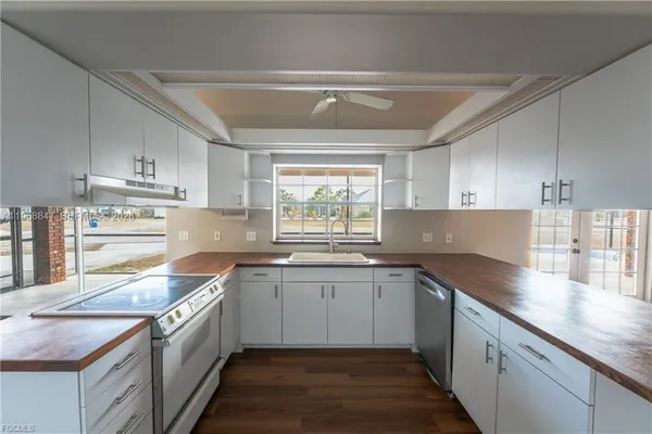 a kitchen with a sink stove and cabinets