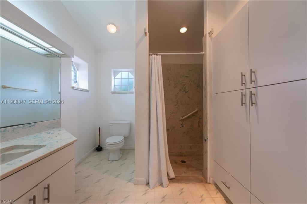 845 Quail Run LaBelle, FL 33935 - Photo 15 of 29 a bathroom with a granite countertop sink toilet and shower
