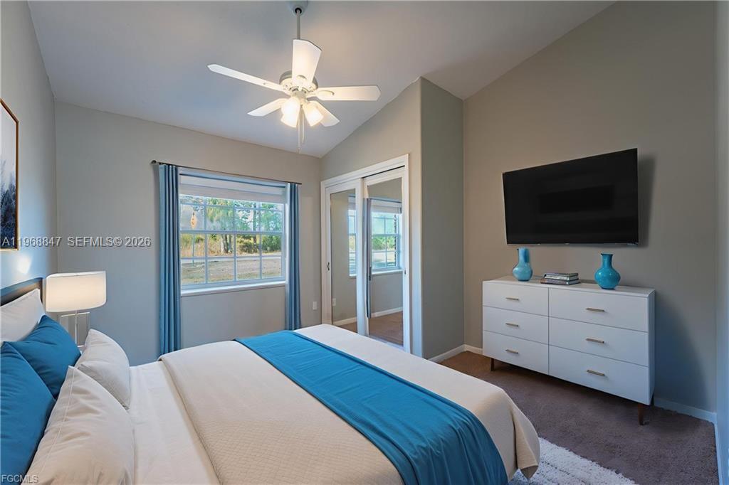 845 Quail Run LaBelle, FL 33935 - Photo 19 of 29 a bedroom with a bed and a flat screen tv